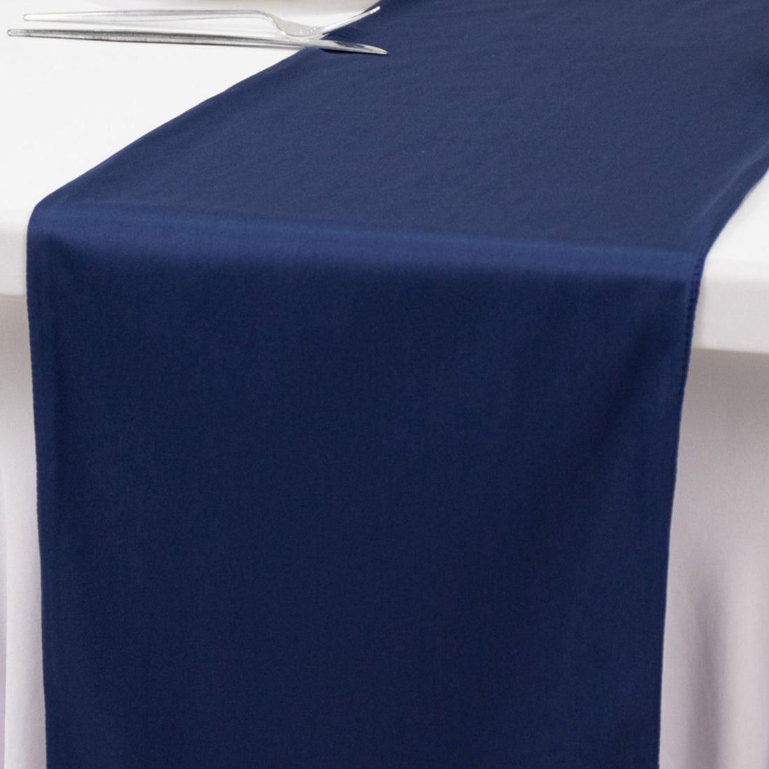 Navy table runner on a white table surface.