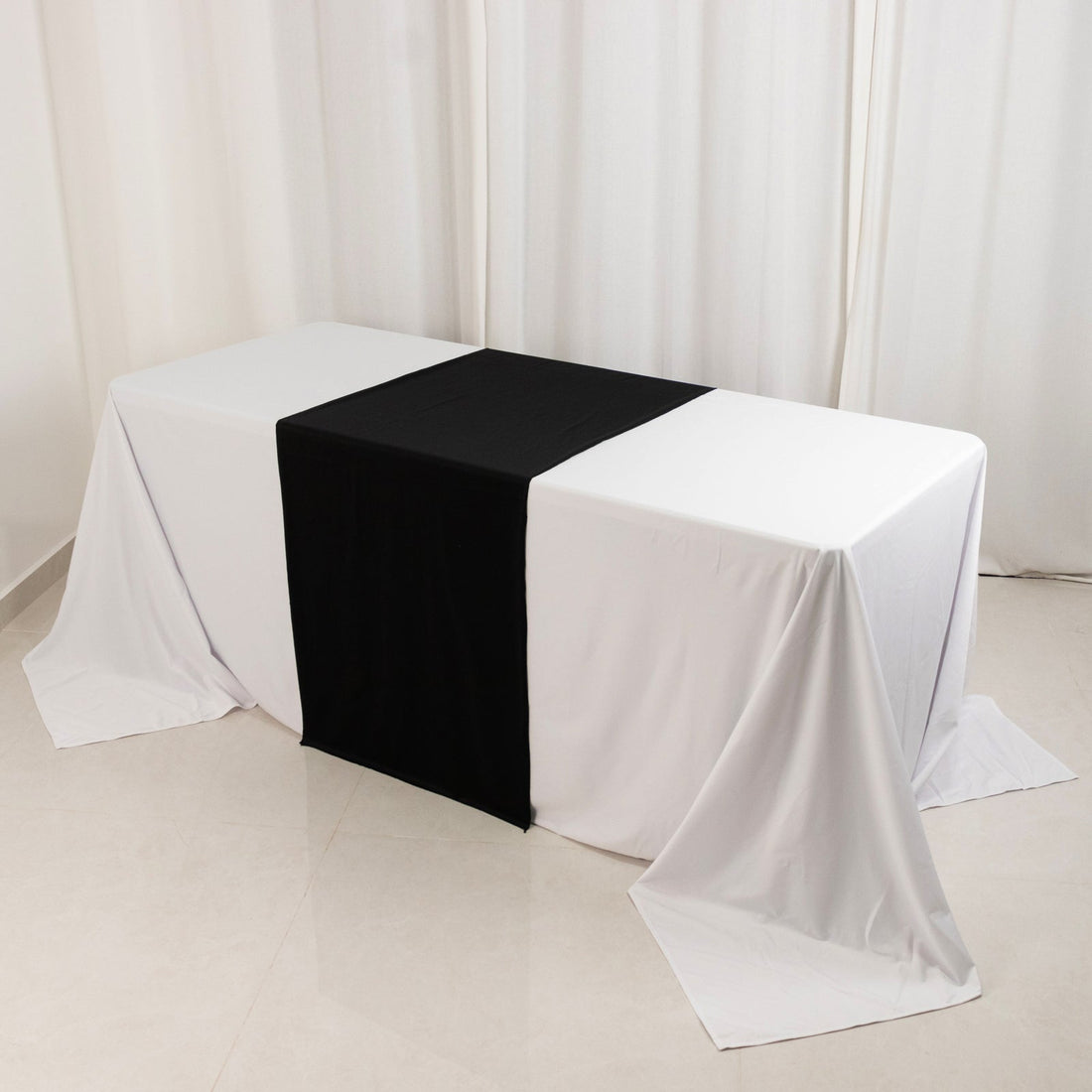 Table with white and black linens in a studio setting