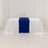 White table with blue runner on a plain backdrop