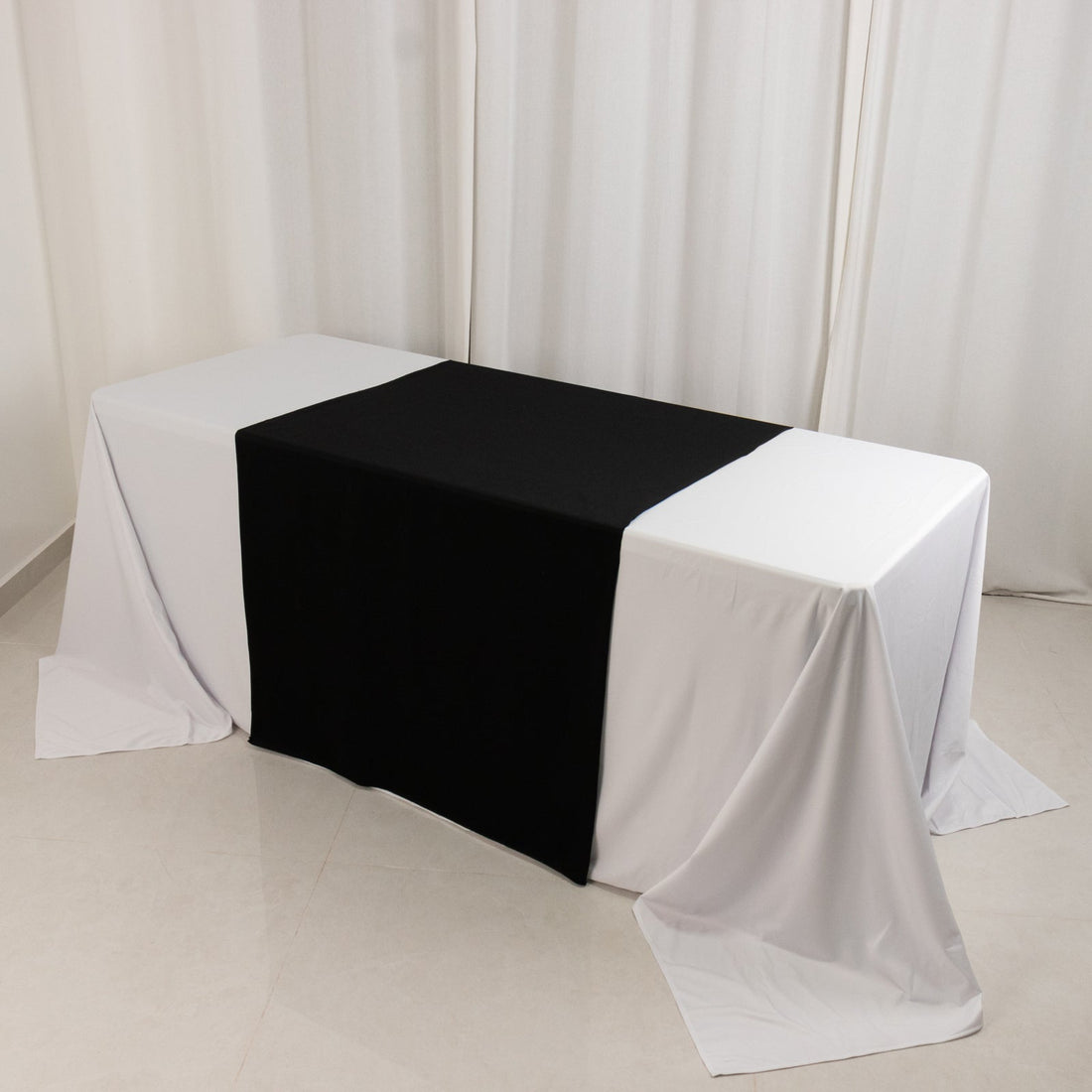 Table with black and white tablecloths arranged in a stylish setup.