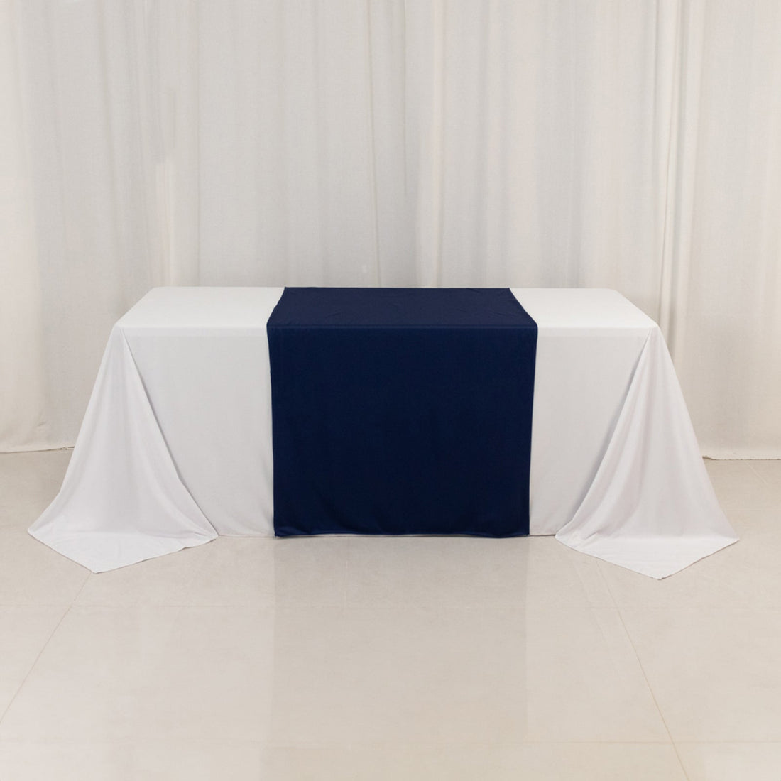 Table with navy and white draping on a plain background.