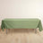 Green tablecloth draped over a folding table on a wooden floor.