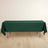 Green tablecloth draped over a table on a light wooden floor.