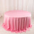 Round pink tablecloth draped elegantly over a circular table