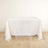 White tablecloth draped over a table on a light wooden floor.