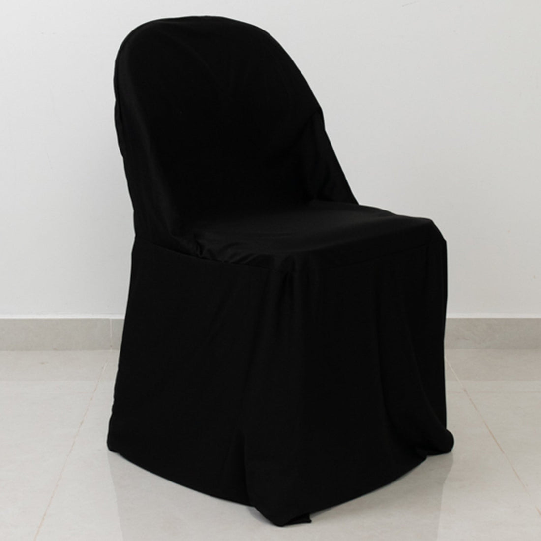Black chair cover on a plain backdrop