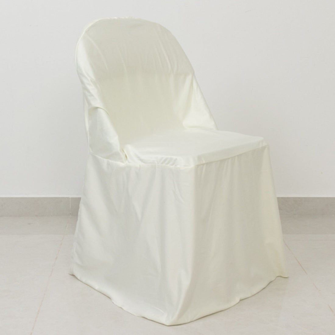 White satin chair cover draped over a chair, showcasing its elegant design.