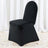 Black chair cover on a plain backdrop with flower petals scattered around.