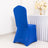 Blue chair cover on a white table in a decorated room.