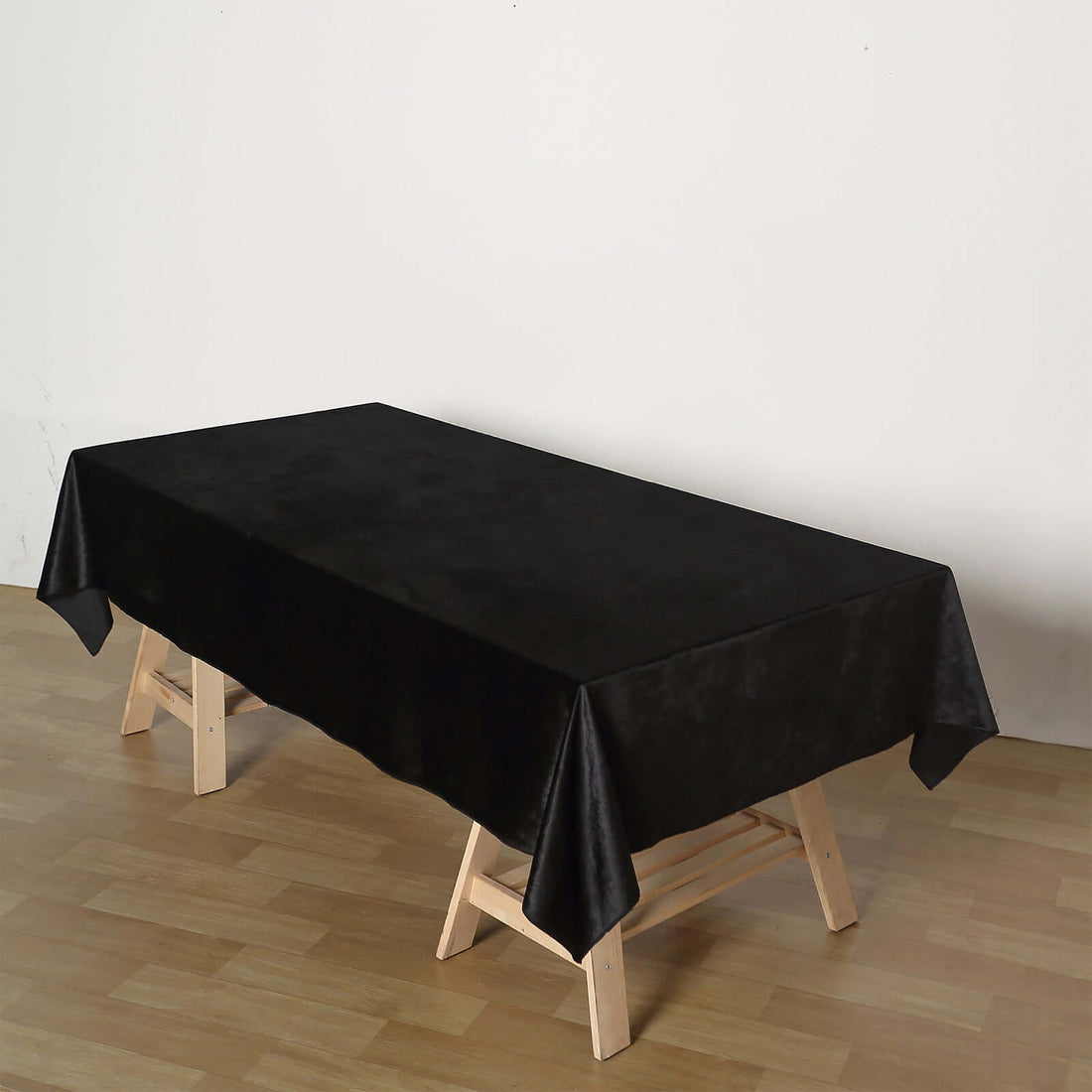 Black tablecloth on a wooden table in a minimalist setting.