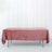 Pink tablecloth draped over a table on a white backdrop.