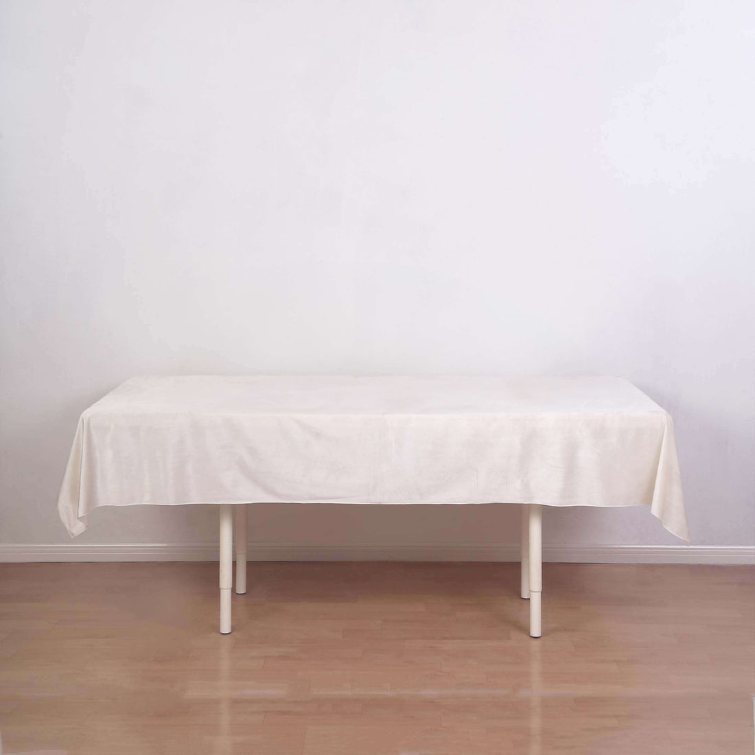 Cream tablecloth draped over a simple white table