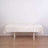 Cream tablecloth draped over a simple white table