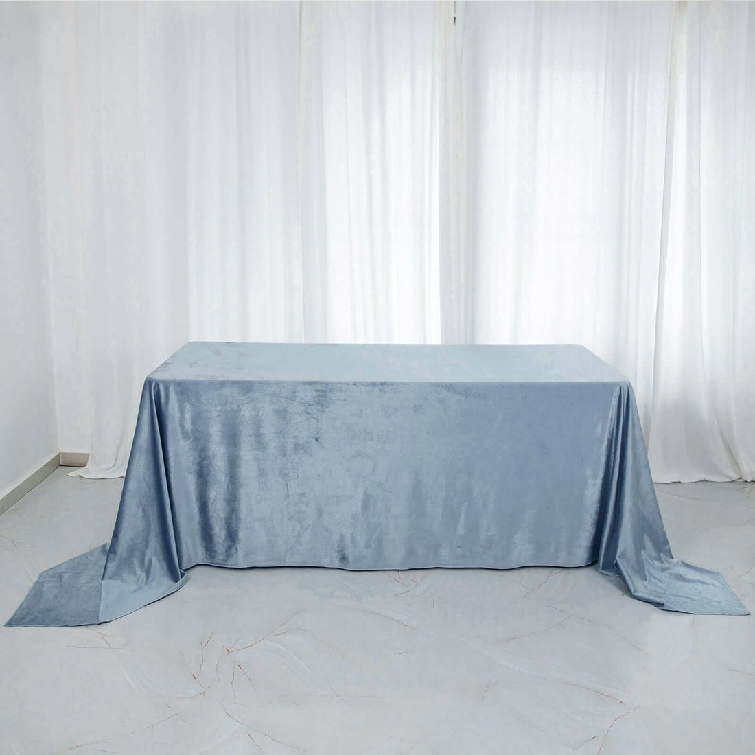 Light blue tablecloth on a table in a bright, airy setting.