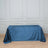 Blue velvet tablecloth on a wooden floor with a textured backdrop.