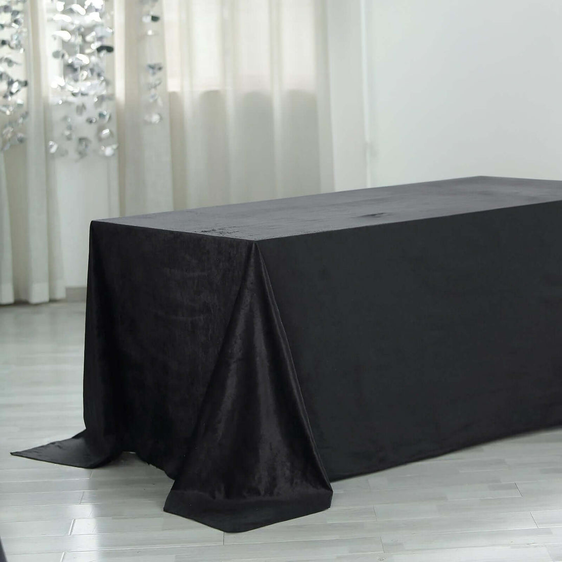 Black tablecloth draped elegantly on a table in a bright indoor setting.