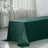 Green velvet tablecloth draped over a table in a bright room.