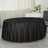 Black round tablecloth draped elegantly over a table in a bright indoor setting.