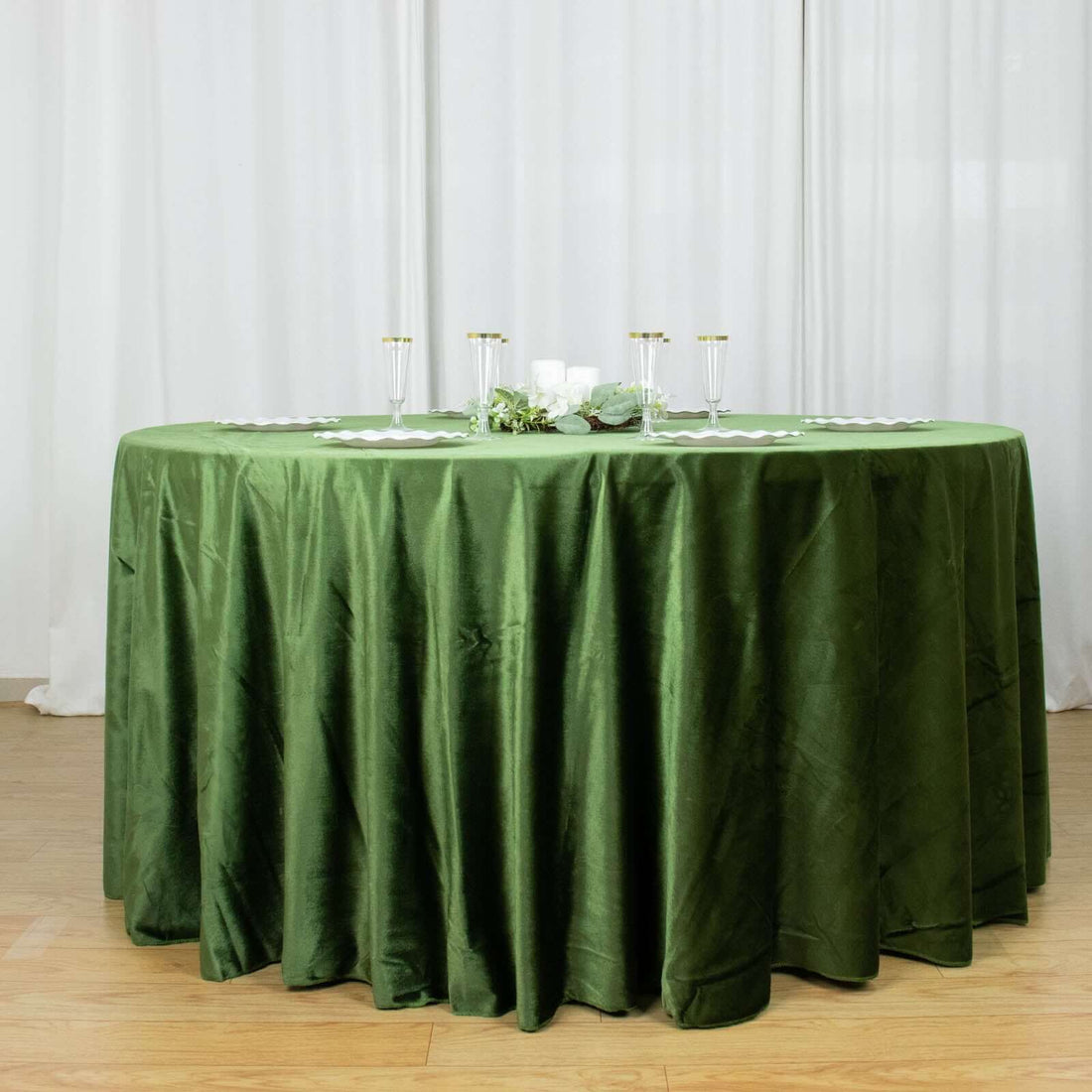 Round green tablecloth elegantly draped on a round table for events and gatherings.