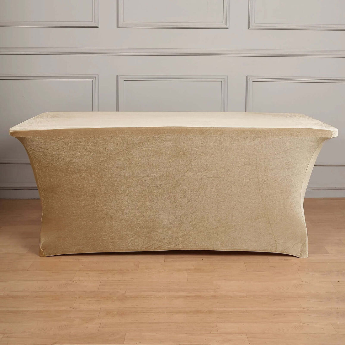 Gold tablecloth draped over a rectangular table in a studio setting.
