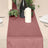 Elegant maroon table runner with greenery and candles for dining decor.