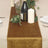 Elegant brown table runner with candles and decorative greenery.