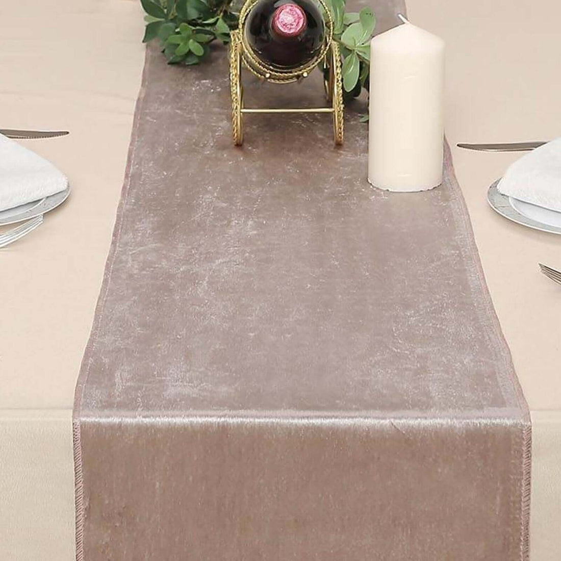 Elegant taupe table runner styled with candle and wine for dining decor.
