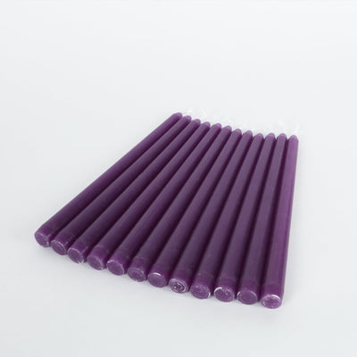 Purple taper candles arranged neatly on a white background.