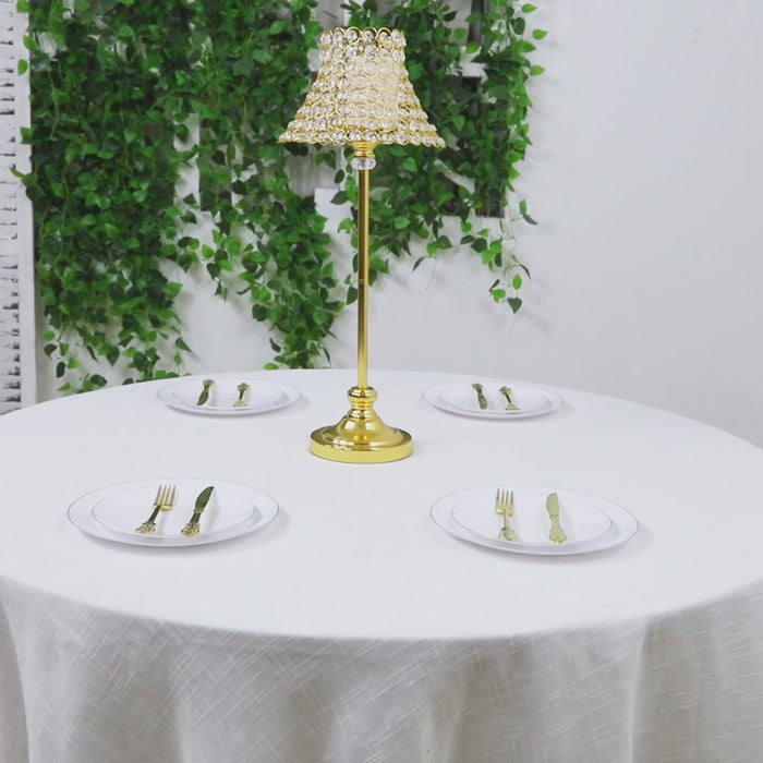 Gold centerpiece stand with crystal beaded shade on a table setting.