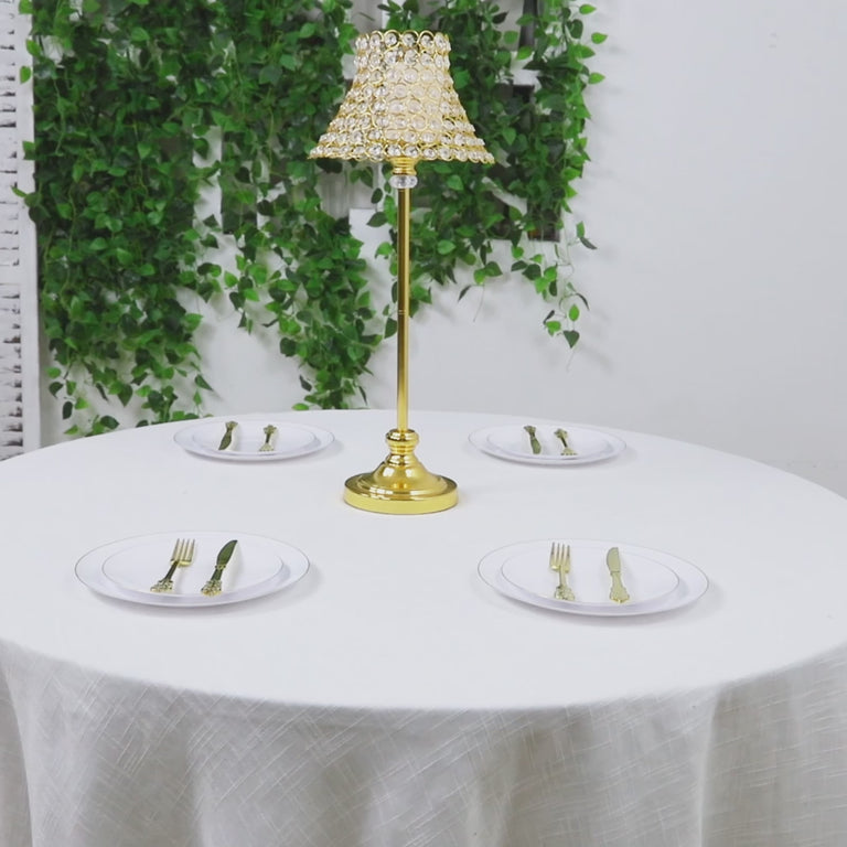 Gold centerpiece stand with crystal beaded shade on a table setting.