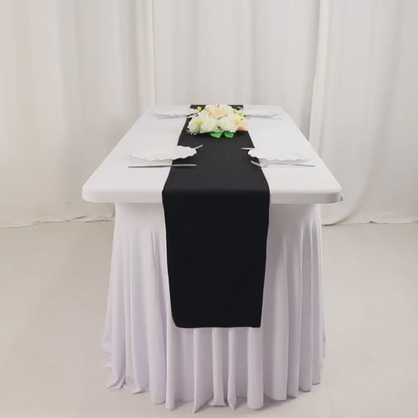 Black wrinkle-free table runner on a white table for events and weddings.