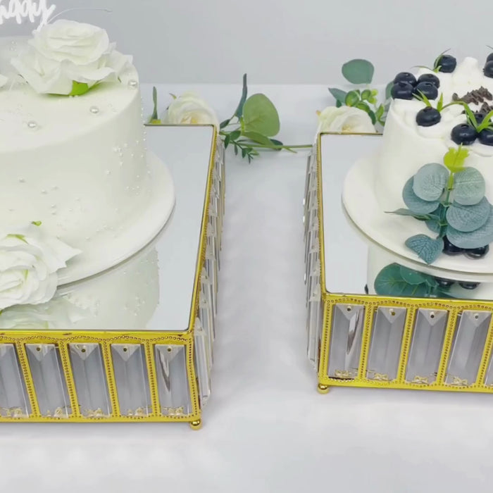 Gold crystal cake stands with mirror tops, displaying elegant desserts.