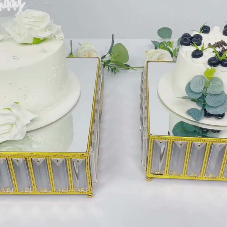 Gold crystal cake stands with mirror tops, displaying elegant desserts.