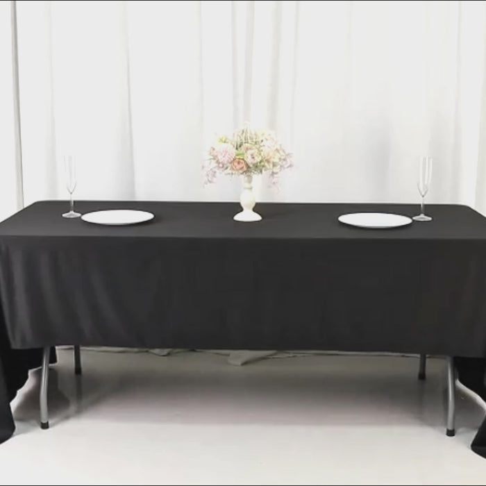 Black fire retardant tablecloth on a dining table, wrinkle-free and stain-resistant.