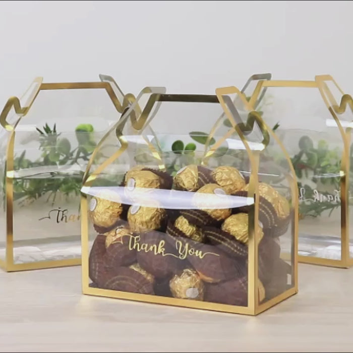 Gold trimmed clear PVC tote gable boxes filled with candies, featuring a "Thank You" print.