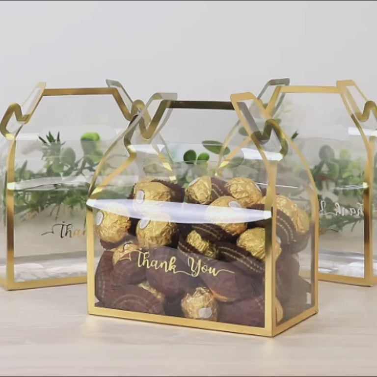 Gold trimmed clear PVC tote gable boxes filled with candies, featuring a "Thank You" print.