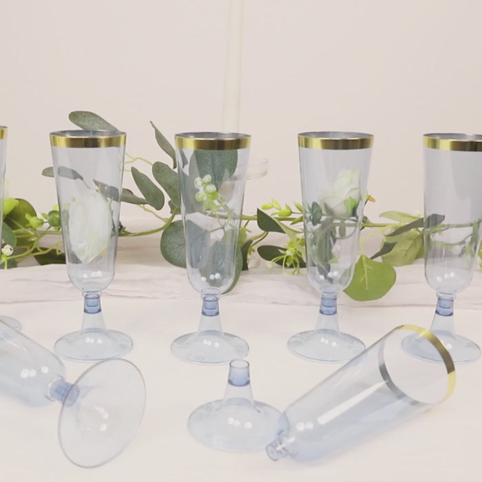 Dusty blue champagne flutes with gold rim, disposable and elegant for toasting.