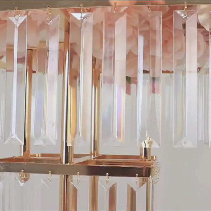 Gold crystal chandelier centerpiece with hanging crystals.
