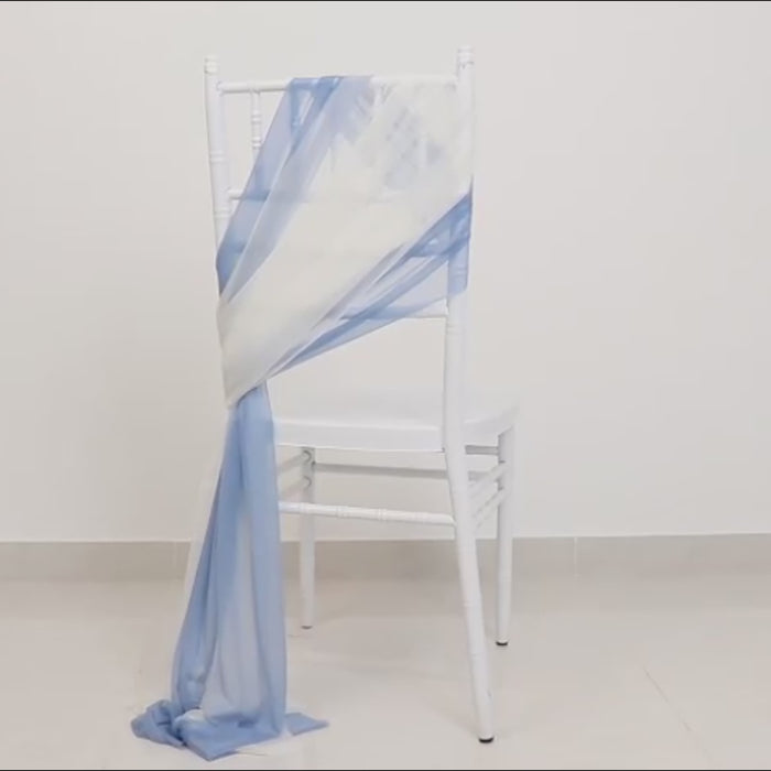Dusty blue and ivory sheer chair sash draped elegantly on a white chair.