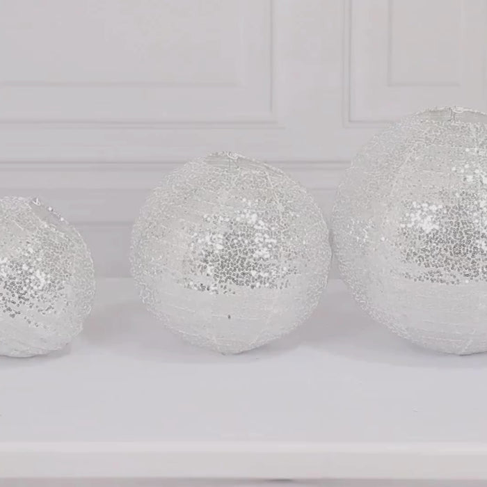 Shimmering silver sequin hanging lanterns in three sizes.