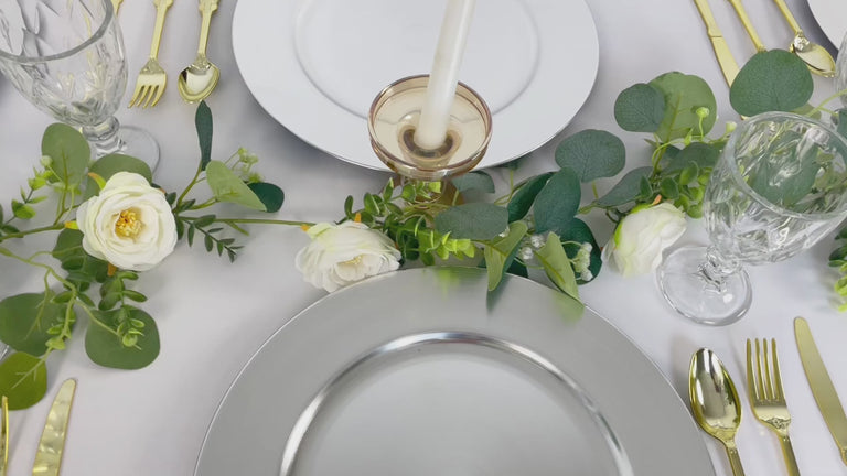 Metallic silver charger plates for elegant dining table settings.
