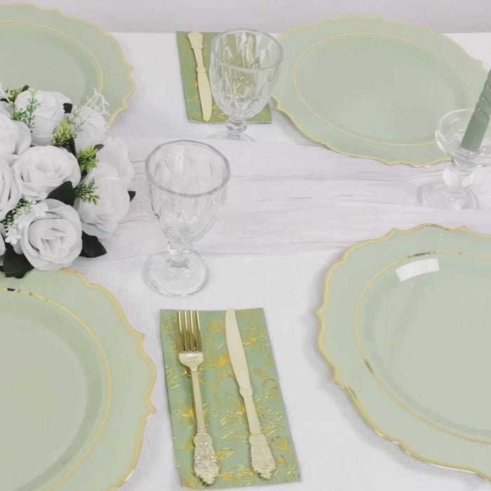Sage green charger plates with gold scalloped rim on a decorative dinner table.