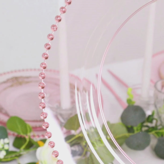 Transparent blush charger plate with beaded rim for stylish dinner parties.