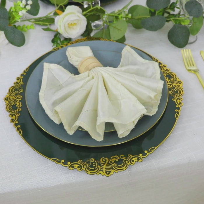 Hunter emerald green charger plate with gold embossed rim on a table setting.