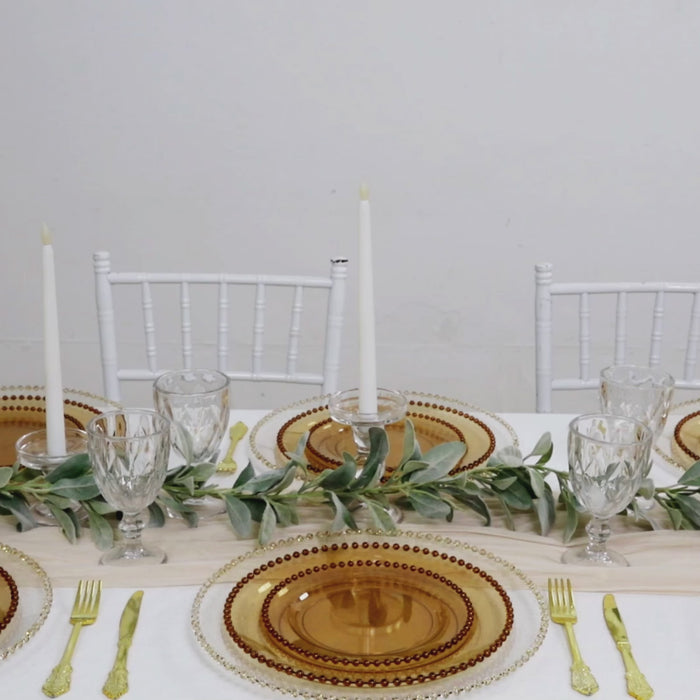 Amber gold disposable dinner plates with beaded rim set on a stylish table setting.