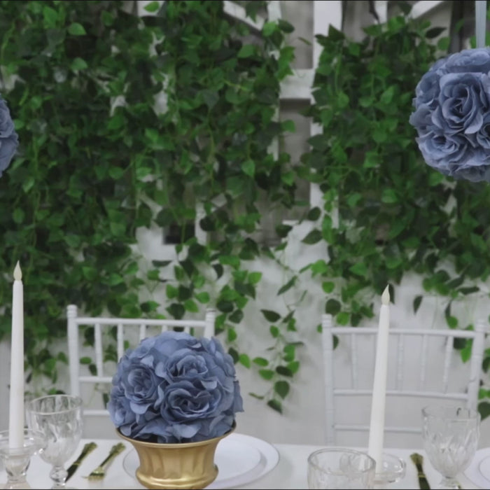 Dusty blue artificial silk rose kissing ball centerpiece on a dining table.