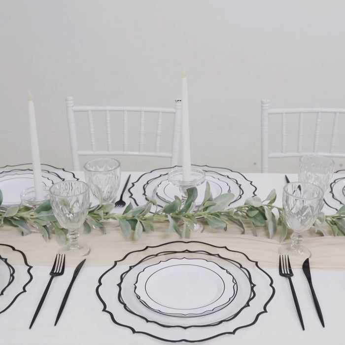Clear charger plates with black scalloped rim, perfect for dinner parties.