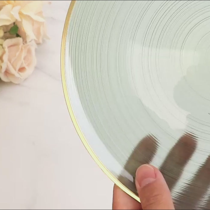 Transparent dusty sage green bowl with a gold rim. Elegant swirl design.