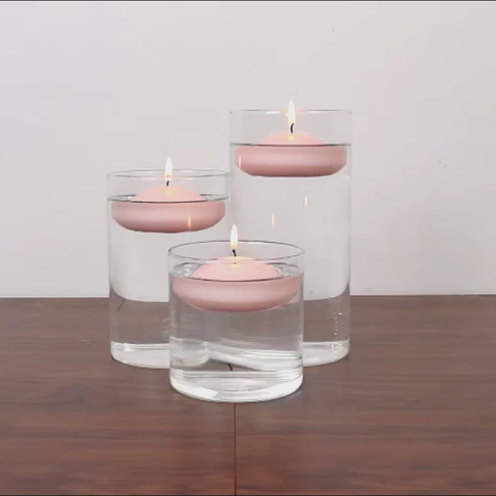 Blush floating candles in water for elegant centerpieces.