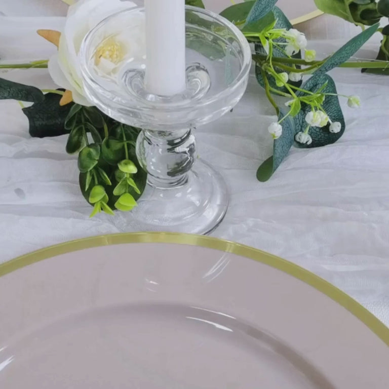 Taupe charger plate with gold rim on elegant tabletop decor.